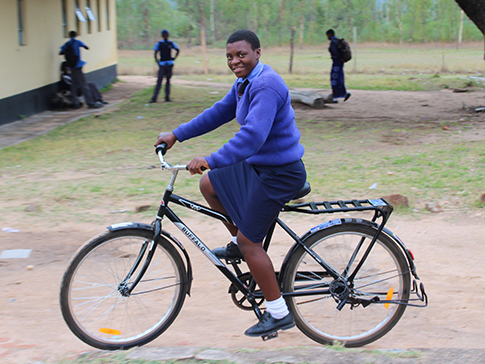 Aneni, a CAMFED scholar in Zimbabwe, on her new bike. Aneni, a CAMFED scholar in Zimbabwe, on her new bike.
