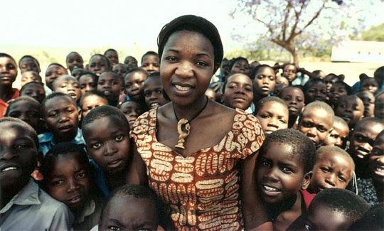 Angie Murimirwa with school children in 2003 in Zimbabwe