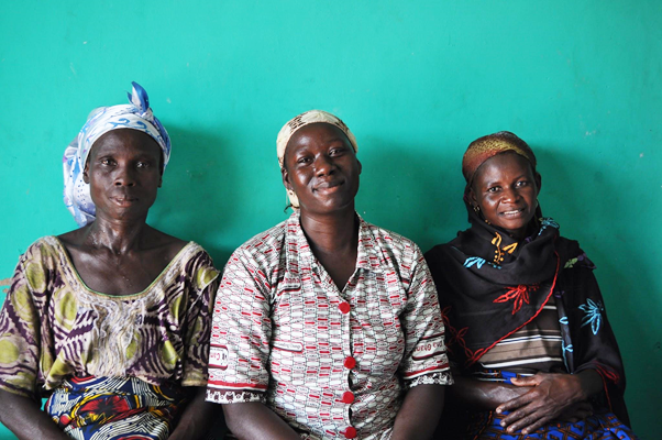 Ayisha sitting with two of the women she employs in her business