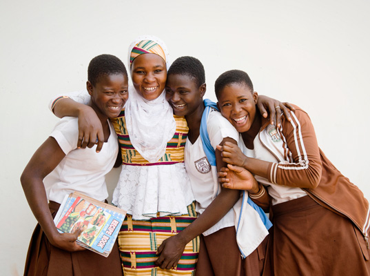 Camfed alumna Hawa with three school girls