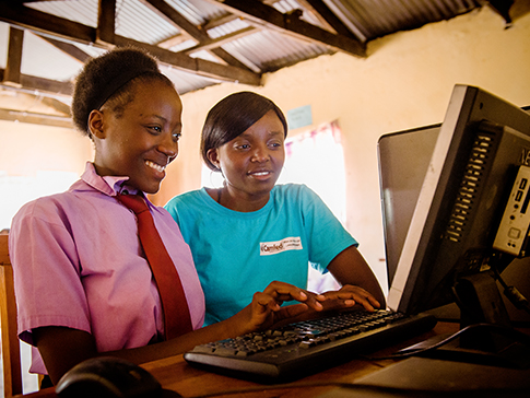 Alice helping Faith at the computer
