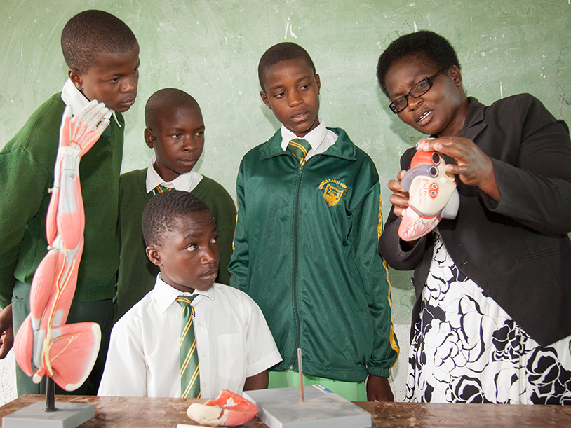 Lameck’s student group with his biology teacher and a model of organs