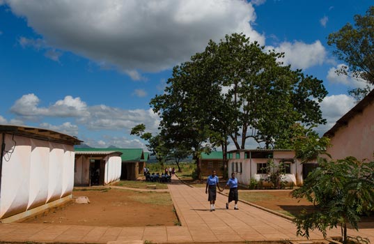 Two students walking across school grounds in Malawi Study circles in the school grounds