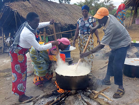 Aida Kalolo cooking with a Parent Support Group