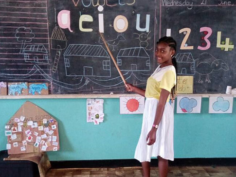 CAMFED alumna Alice from Zambia, ECD teacher at the blackboard