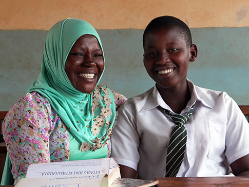 Dotto (left) a Learner Guide from Tanzania, provides holistic support to student Hadija. Dotto (left) a Learner Guide from Tanzania, provides holistic support to student Hadija.