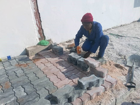 Misozi laying bricks