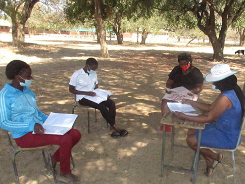Young women learning in distanced groups in rural Africa