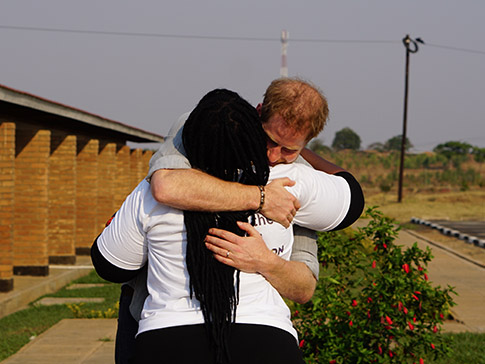 The Duke of Sussex hugs Angie Murimirwa