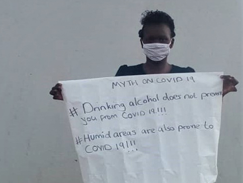 Tisiyenji holding an educational poster Tisiyenji holding an educational poster