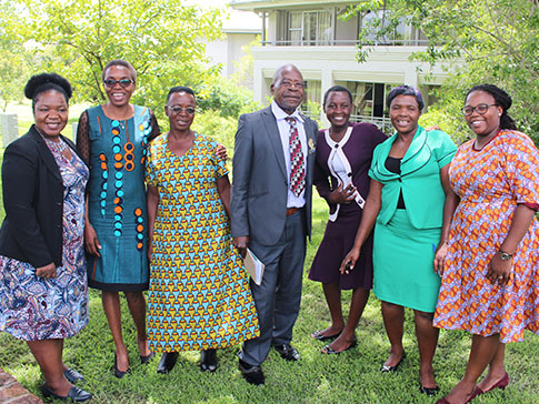 Faith (second from left) with CAMFED Association and community leaders. 