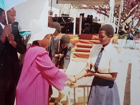 Lucia receives a prize at secondary school