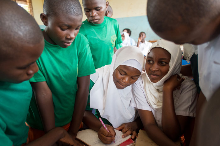 Tanzanian students supported by a Camfed alumna Learner Guide