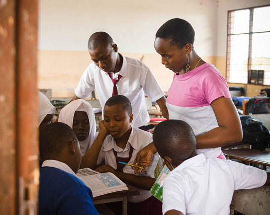 Students in a Camfed partner school running the Learner Guide Program in Tanzania.