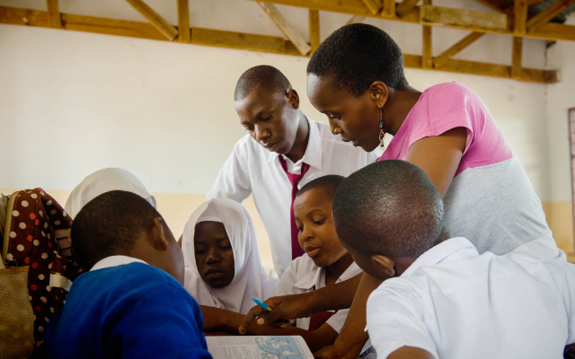 Tusekile supporting students in the classroom